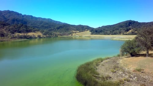 View Of Gorgeous Mountainside Lake On Sunny Day By Aerial Drone