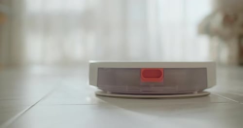 Robot Vacuum Cleans Tiled Floor Indoors