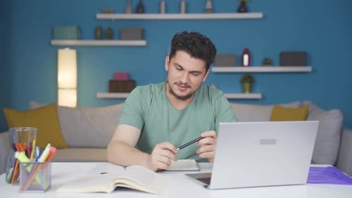 Young Adult Video Calling on Laptop at Home