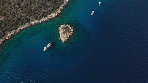 Aerial View of Boats Sailing Near Island in Turquoise Water