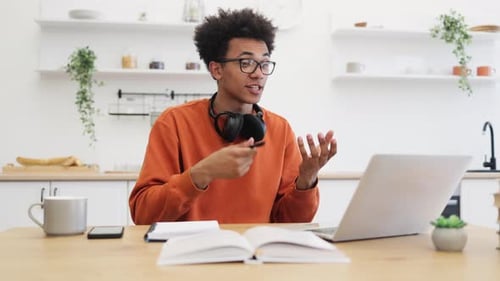 Young Man Video Conferencing at Home in Kitchen