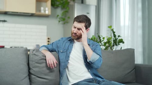 Man Massaging Temples Suffering from a Headache