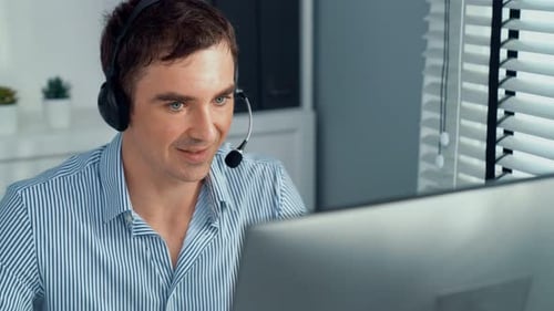 Competent Male Operator Working with Customers in the Office