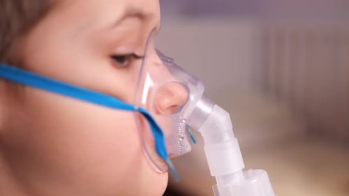 Child Using Nebulizer Mask for Respiratory Treatment