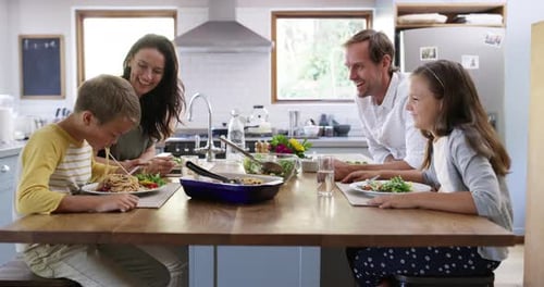 Happy Family Eating Together in Sunny Kitchen