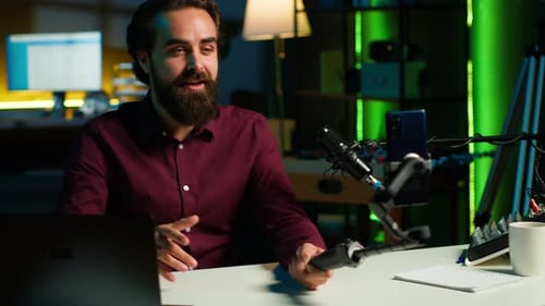 Man Using Phone Camera and Professional Microphone to Record