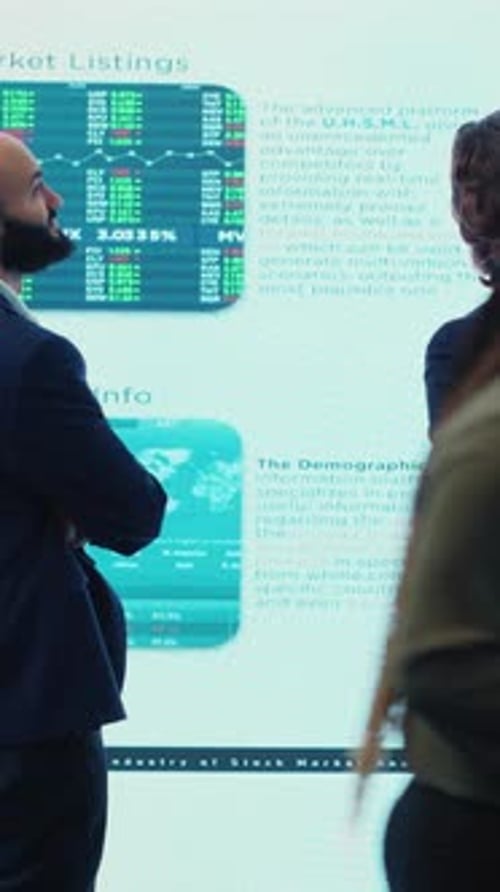 Vertical Video Business Partners Reviewing Latest Budgeting Plans a Big Screen