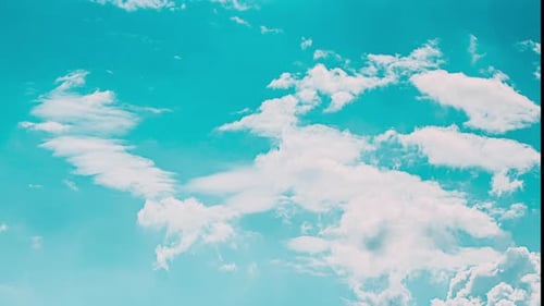 Clouds timelapse moving quickly on blue sky