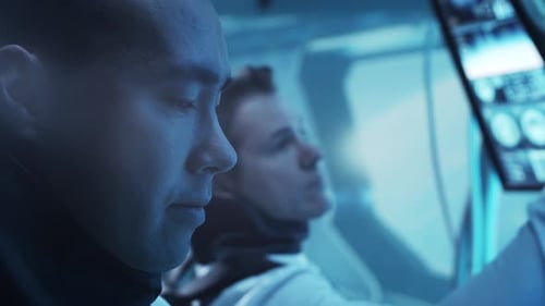 Team of Astronauts in a Space Suits Aboard the Orbital Station A Crew of Cosmonauts Piloting the