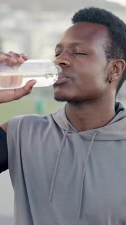 Man, fitness and runner drinking water outdoor for exercise hydration, running recovery and health
