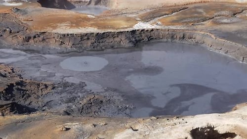 Hverir geothermal area which pools of boiling mud and hot springs in Iceland. A surreal, bare orange