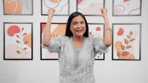 Woman Celebrates with Fists Raised in Joy