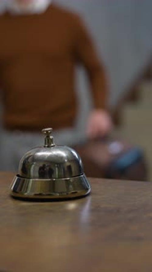 Hotel Guest Ringing Service Bell at Reception Desk
