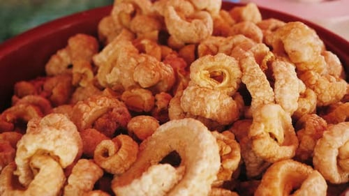 Enjoy a Bowl of Deliciously Crunchy Pork Rinds Perfect for Any Gathering or Snack Occasion
