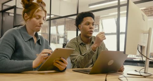 Young Adult Business People Meeting in Office and using Computer Technology