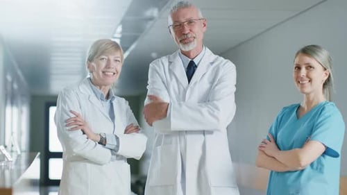 Portrait of Doctors and Nurses Posing in the Hospital Building, Arms Crossed and Smiling. Brilliant