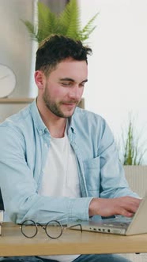 Portrait of Goodlooking Man Which Online Corresponding with Mates on Laptop in Home Office or Doing