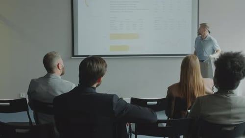 Business Presentation with Speaker and Audience in Room