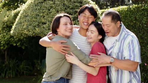 Happy Family Hugging in the Sunny Garden