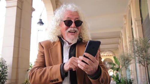 Senior Man Using Smartphone in Urban Setting