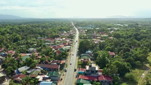 Slow Landscape Orbital Aerial of Tropical Philippine Town and Road Traffic 4K