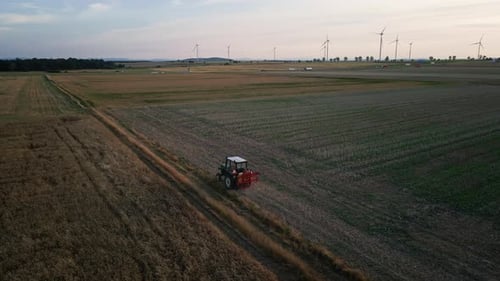 Small Tractor Cultivating Soil at Agricultural Field Aerial View