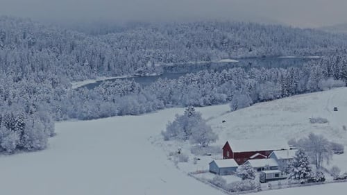 Countryside House In Deep Snow Landscape Near Forest Mountain Lake. Aerial Shot
