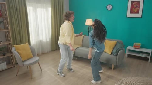 A Curly Guy and a Young Asian Woman Spend Time Together at Home on a Day Off Young Couple Having Fun