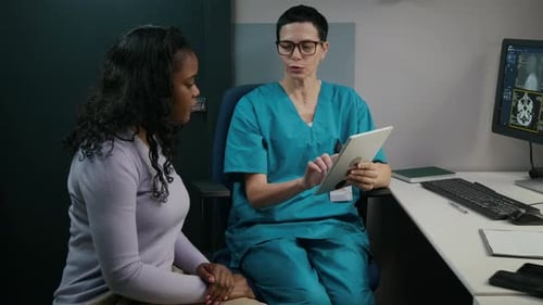 Doctor Explains X-Ray Results to Patient in Hospital