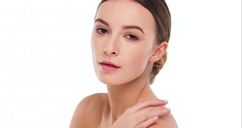 4k video footage of a beautiful young woman posing against a studio background