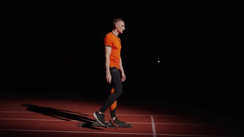 Professional Sportsman On Sprint Lane In Stadium Runner Preparing To Start Cardio Workout