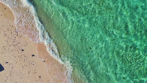 Aerial View of Waves on Sandy Beach