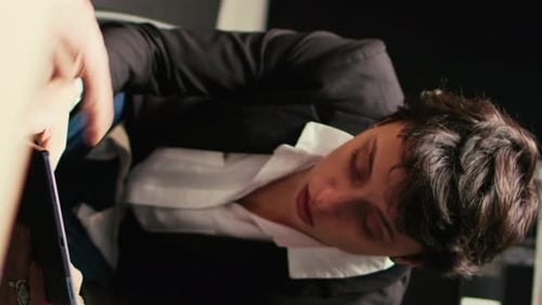 Stressed Young Adult in Modern Office Rubs Face