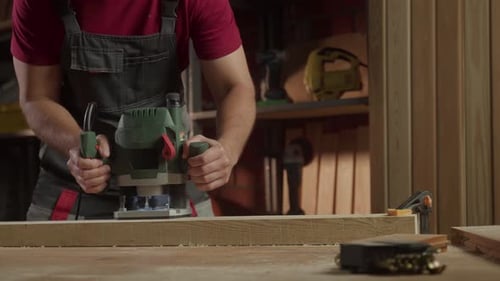 In a Cozy Woodworking Shop an Individual Operates a Milling Machine to Craft Precise Wooden Pieces