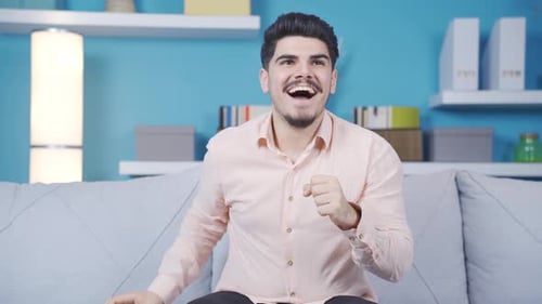 Man Celebrates Good News on Mobile Phone