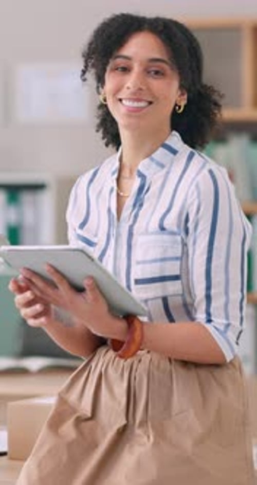 Woman Smiling with Tablet Device in Office