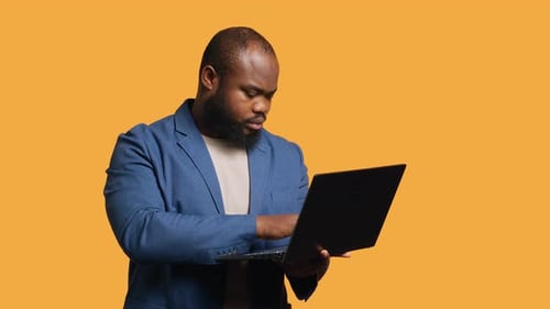 Office Clerk Doing Budgeting on Laptop Studio Background