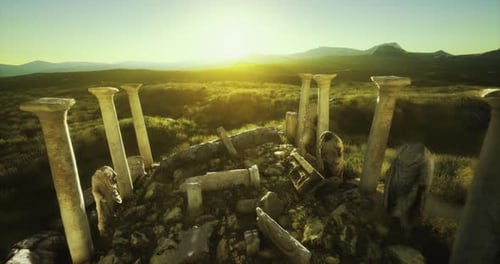 Ruins of Ancient Columns Against a Sunrise in a Historical Landscape