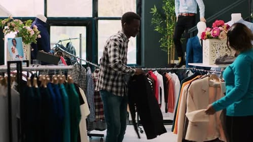 Man Dances While Shopping in Clothing Store