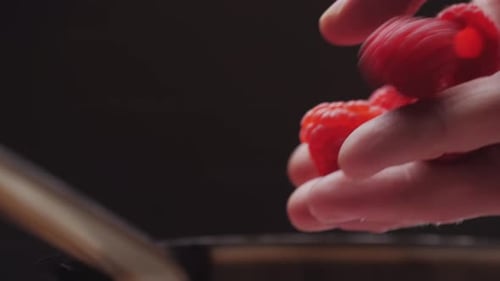 Juicy Raspberries Dropped Into Pan for Cooking