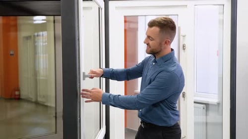 Friendly Manager in Window Shop Makes a Presentation of New Products