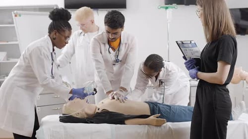 Medical professionals conduct examination on medical dummy at a first aid course