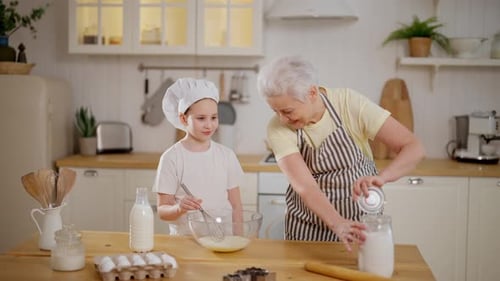 Girl and Woman Baking Together in Kitchen