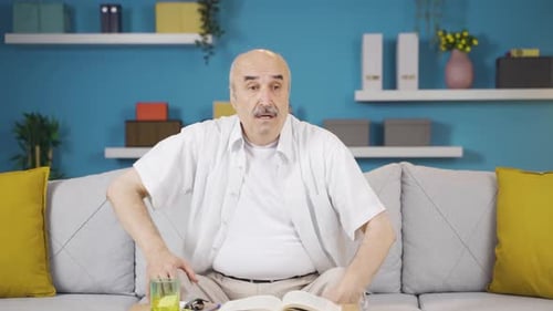 Man on Couch Experiencing Chest Pain