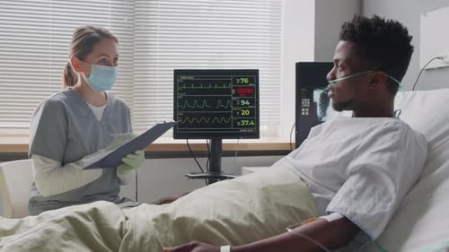 Nurse Checking on Patient after Surgery in Hospital Ward