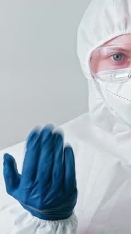 Person in Protective Suit Pointing Finger