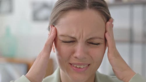 Close up of Young Woman with Headache at Home