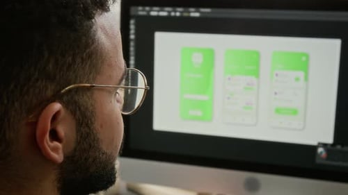Man Designs Mobile App On Computer Screen