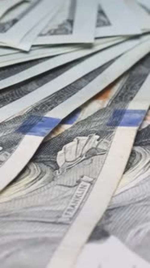 Macro Video of US 100 Dollar Bills Spinning on the Table Dollar Bills Rotate in a Circle Vertical