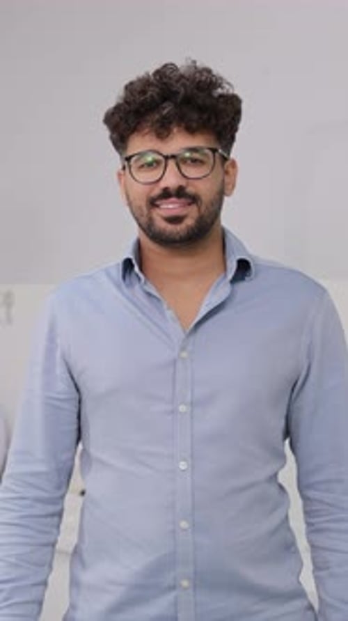 Man with Glasses Gives a Thumbs Up Indoors